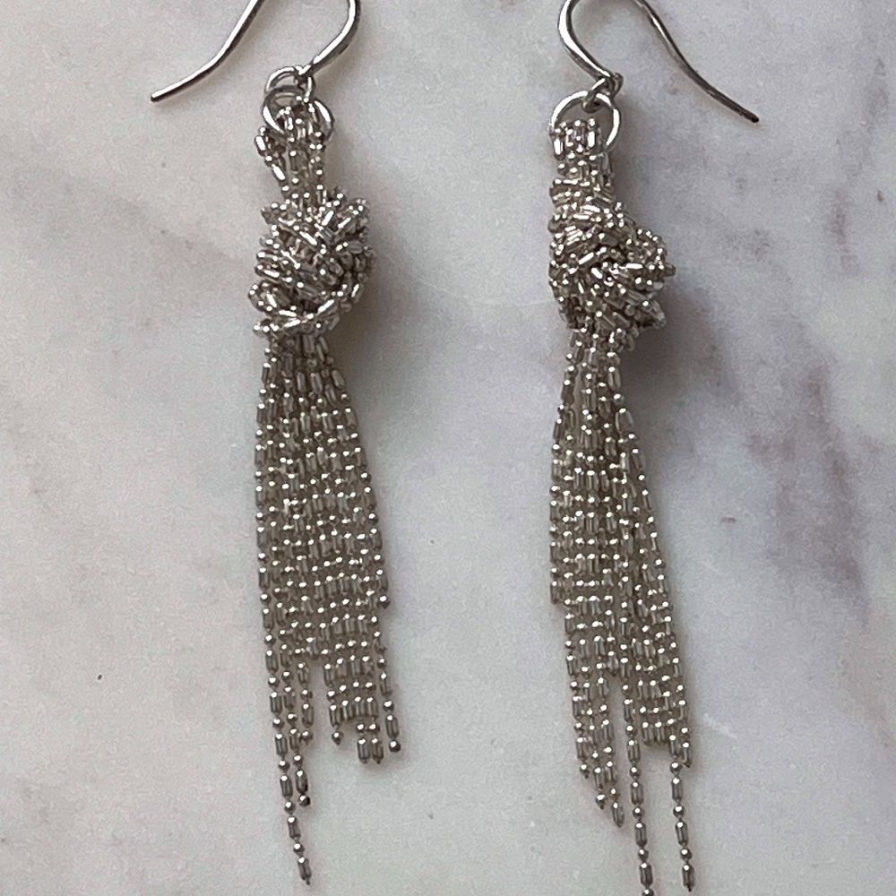 Bright silver knotted drop earrings
